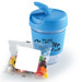 A blue reusable coffee cup with a lid next to a pack of colorful jelly beans. The cup features a logo. A blue reusable coffee cup with a lid next to a pack of colorful jelly beans. The cup features a logo.
