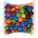 A pillow pack filled with colorful M&M's in various shades, including red, blue, green, yellow, brown, and orange. A pillow pack filled with colorful M&M's in various shades, including red, blue, green, yellow, brown, and orange.