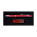 A red pen and a red USB flash drive are presented on a black textured background. The pen has a silver clip. A red pen and a red USB flash drive are presented on a black textured background. The pen has a silver clip.