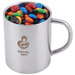 A stainless steel mug filled with colorful M&M's candies, featuring a logo that reads "Mothers Day Appeal."