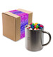 A Java mug filled with assorted color mini jelly beans, placed next to a packaged box. A Java mug filled with assorted color mini jelly beans, placed next to a packaged box.