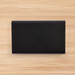 A sleek black Octavius 8,000mAh Power Bank is displayed on a wooden surface. A sleek black Octavius 8,000mAh Power Bank is displayed on a wooden surface.