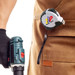 A retracting tape measure labeled "Exocet 5m" is attached to a worker's waist, alongside a cordless drill in their hand. A retracting tape measure labeled "Exocet 5m" is attached to a worker's waist, alongside a cordless drill in their hand.