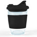 A reusable coffee cup with a clear body and a black snap lid and sleeve for grip. A reusable coffee cup with a clear body and a black snap lid and sleeve for grip.