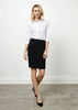 A fitted women's knee-length skirt in black, paired with a white button-up shirt and black heels. A fitted women's knee-length skirt in black, paired with a white button-up shirt and black heels.
