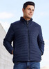 A men's puffer jacket in navy blue, featuring a zip front and standing collar, worn by a model outdoors. A men's puffer jacket in navy blue, featuring a zip front and standing collar, worn by a model outdoors.