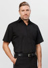 A black short sleeve button-up shirt with a collar, modelled by a man. The shirt features a logo.