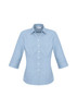 A women's 3/4 sleeve button-up shirt in a light blue check pattern, featuring a classic collar and a logo.
