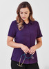 A plain short sleeve shirt in purple, featuring a button-up design and a chest pocket, held by a woman with a stethoscope. A plain short sleeve shirt in purple, featuring a button-up design and a chest pocket, held by a woman with a stethoscope.
