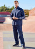 A pair of navy unisex track pants features a sporty design with contrasting stripes and a logo. A pair of navy unisex track pants features a sporty design with contrasting stripes and a logo.