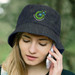 A denim bucket hat with a logo, worn by a person speaking on a phone. The hat is dark blue.