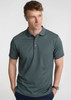 A men's short sleeve polo in a deep green colour, featuring a classic collar and a logo on the chest.