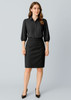 A black mid-waist pencil skirt paired with a black button-up blouse, featuring puffed sleeves.