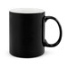 A coffee mug featuring a sleek black exterior with a contrasting white interior.