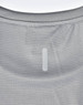 A light grey performance t-shirt featuring a textured pattern and a logo patch on the back.