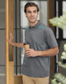 Men's short-sleeve polo in grey with teal contrast detailing, featuring a logo. Styled for a casual look.