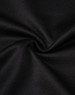 A close-up view of black sustainable poly/cotton fabric with a smooth texture and slight stretch.