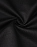 A close-up of black fabric, showcasing a smooth texture with a slight stretch, typical of polo shirt material.