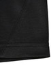 A close-up of a black sustainable poly/cotton polo shirt showing the hem and stitching details. Features a logo.