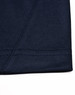 A close-up of a navy blue polo shirt sleeve with contrasting stitching detail. The fabric shows a smooth texture.