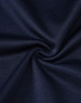 A close-up of dark navy fabric with a smooth texture, showcasing the sustainable poly/cotton blend.