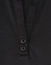A close-up of a black polo shirt featuring a collar and two buttons at the neckline. The shirt has a logo.