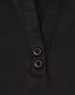 A black short-sleeve polo shirt featuring a placket with two buttons and a logo.