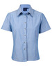A short-sleeve ladies' button-up shirt in light blue chambray with a collar and shiny buttons.