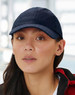 A white athletic mesh cap featuring a rounded crown and a stiff peak, complete with a logo.