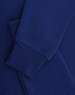 A blue crewfleece jumper featuring a close-up of the sleeve and cuff details. It has a small logo.