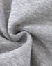 A close-up of soft, grey fabric with a slight texture, typical of a fleece jumper. It features a logo.