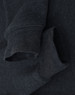 A dark grey crewneck sweatshirt featuring a soft fleece texture and rolled cuffs. It has a logo near the neckline.