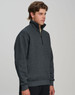 A casual 1/2 zip collar fleecy jumper in dark grey, featuring a branded logo. Suitable for cool weather.