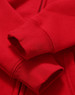 A red full-zip fleecy hoodie featuring cuffed sleeves and a soft texture, with an additional logo present.