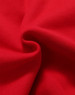 A close-up view of soft, red fleece fabric showing its textured surface. The image features a subtle fold in the material.