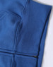 A blue full-zip fleecy hoodie with a pocket, featuring a subtle texture and stitching details.