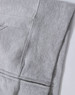 A grey full-zip fleecy hoodie featuring a pocket and a logo. Ideal for casual wear.