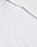 A close-up of a white fleece hoodie featuring a curved shoulder seam and a logo.