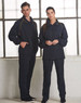 A navy track jacket with yellow accents displayed on models. The jacket features pockets and a collar.