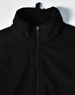 A black men's softshell high-tech jacket with a high collar and zip fastening, featuring a logo.