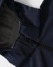 A navy men's softshell full zip hoodie with a grey lining and a zipper closure. Features a hood and logo.