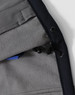A close-up of the interior lining of a navy men's softshell full zip hoodie, featuring a drawstring and a pocket.