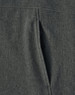 A close-up view of a grey ladies' softshell full zip hoodie showcasing the fabric texture and a zippered pocket.