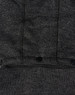 A dark grey fleece jacket featuring a textured fabric and black snap buttons. It has a logo on the garment.