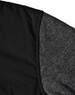 A black quilted jacket featuring a heather grey sleeve. Includes a logo on the fabric.