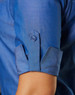 A blue women's button-up shirt featuring 3/4 sleeves with button details and a sleek finish.