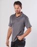 A model wearing a grey short-sleeve polo shirt with a logo on the sleeve, featuring a smooth fabric design.