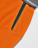 An orange polo shirt featuring a grey collar and a zippered pocket detail. The fabric has a textured finish.