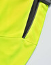 A close-up view of a bright yellow polo shirt featuring a grey accent and a zippered pocket.