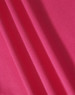 A close-up of textured fabric in a vibrant pink colour, showcasing its structure and weave.